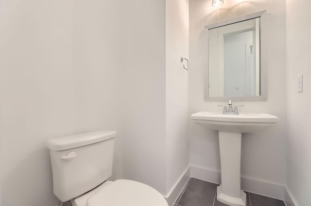 bathroom featuring tile patterned flooring and toilet