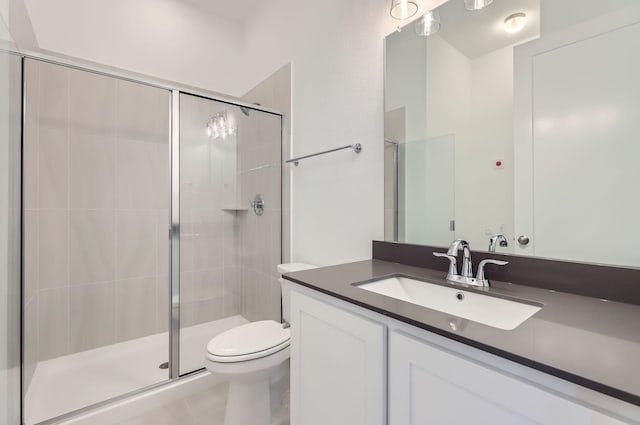 bathroom featuring vanity, toilet, and an enclosed shower