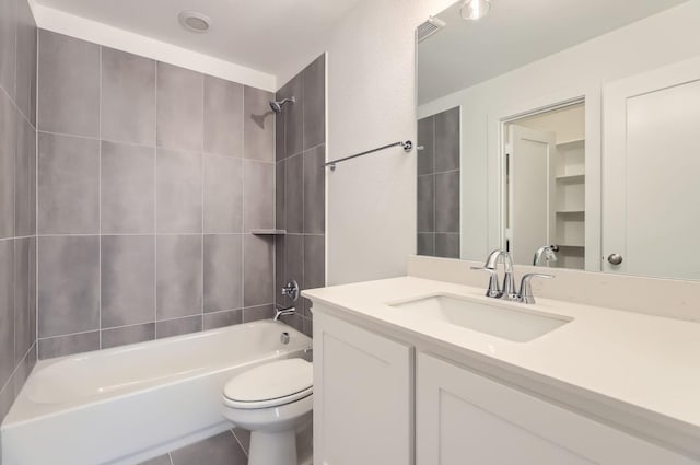 full bathroom with vanity, toilet, and tiled shower / bath