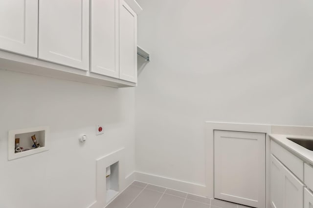 laundry area with washer hookup, electric dryer hookup, cabinets, and light tile patterned flooring