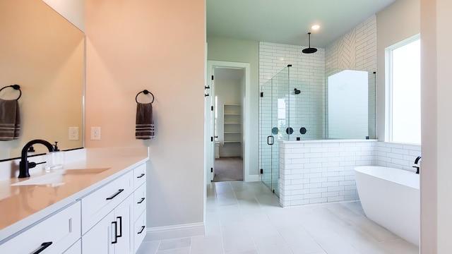 bathroom with vanity and shower with separate bathtub