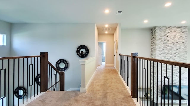 hall featuring light carpet