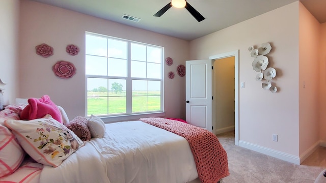 bedroom featuring light carpet and ceiling fan