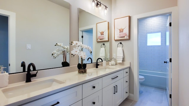 full bathroom with vanity, tiled shower / bath, and toilet