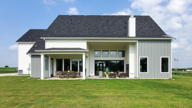 back of property featuring a patio and a lawn