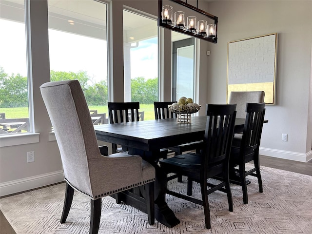 dining room with light hardwood / wood-style flooring and a notable chandelier