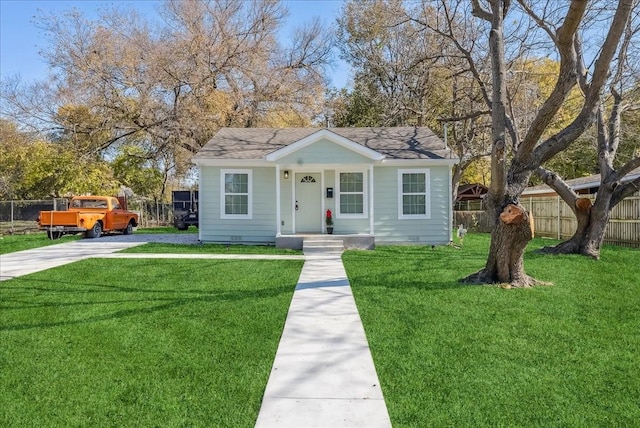 bungalow-style home with a front yard