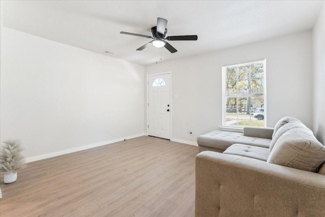 living room with ceiling fan and light hardwood / wood-style floors