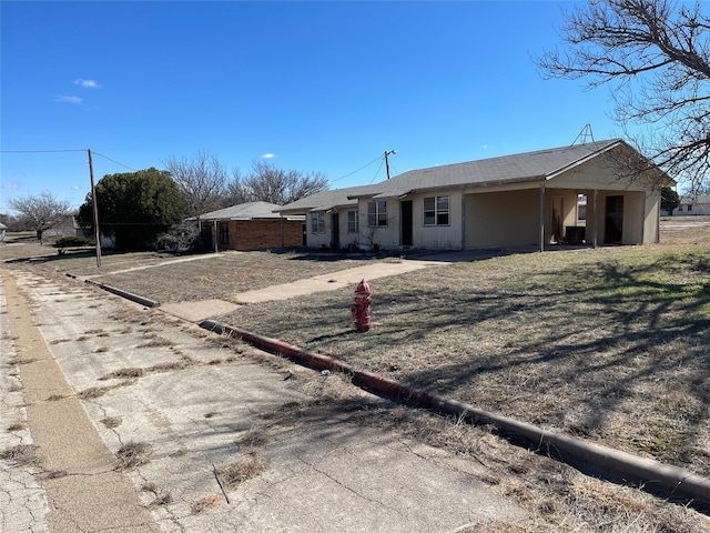 ranch-style home featuring a carport