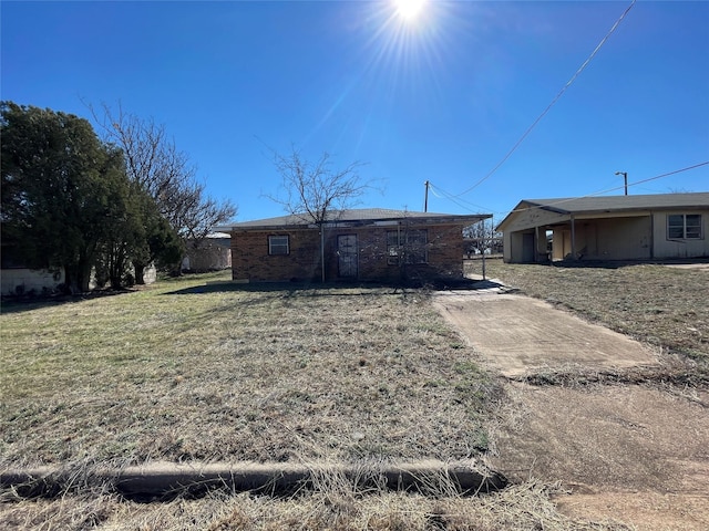 rear view of property with a yard