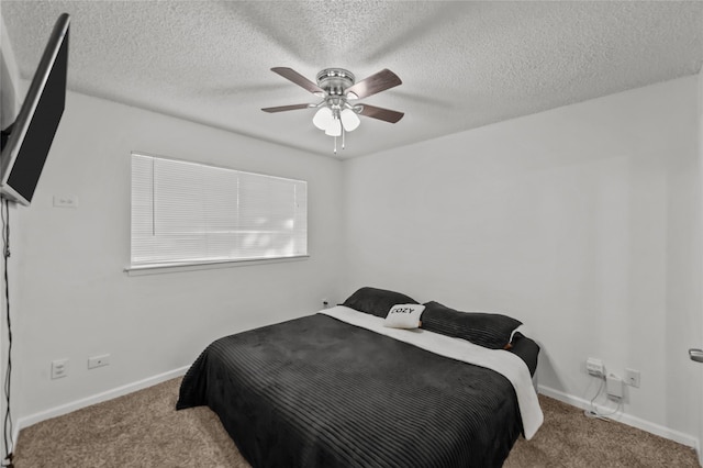 carpeted bedroom featuring ceiling fan and a textured ceiling