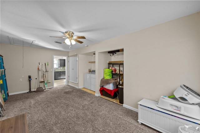 misc room with light carpet, washer and clothes dryer, and ceiling fan