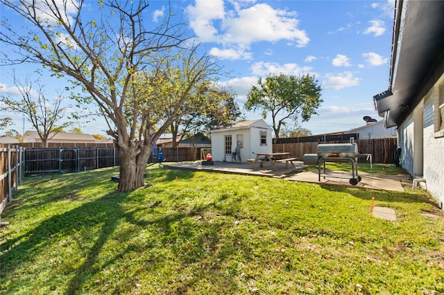 view of yard with a patio and an outbuilding