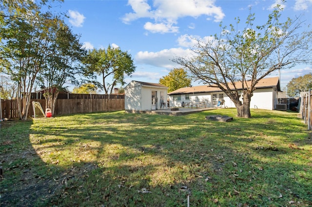 view of yard featuring an outbuilding, a patio, and central AC unit