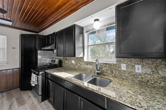 kitchen with sink, stainless steel gas range oven, light hardwood / wood-style flooring, wooden ceiling, and light stone countertops