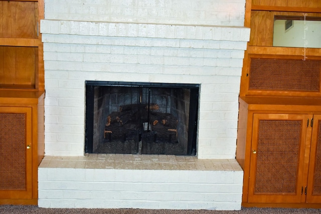 interior details with carpet flooring and a fireplace