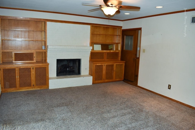 unfurnished living room featuring carpet, ceiling fan, crown molding, and a fireplace