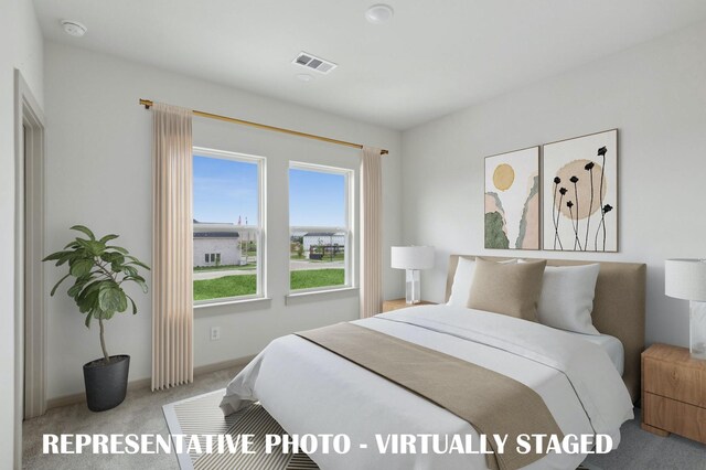 bedroom featuring light colored carpet