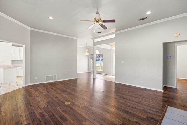 unfurnished living room with ceiling fan, ornamental molding, and dark hardwood / wood-style flooring