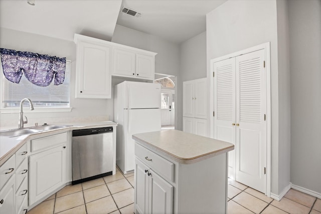 kitchen with a wealth of natural light, white cabinetry, sink, white refrigerator, and stainless steel dishwasher