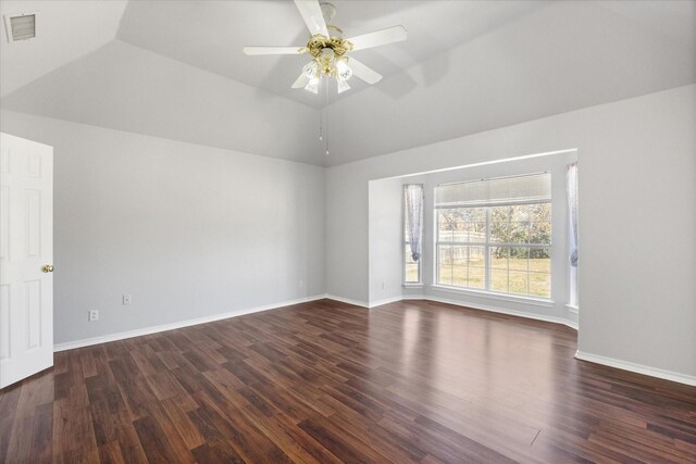 spare room with dark wood-type flooring, ceiling fan, and vaulted ceiling