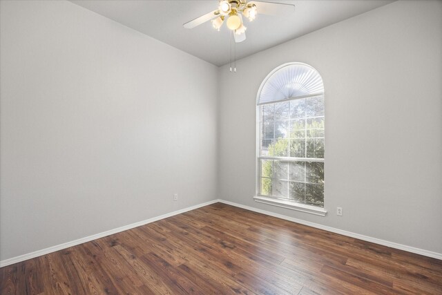 unfurnished room featuring dark hardwood / wood-style flooring and ceiling fan