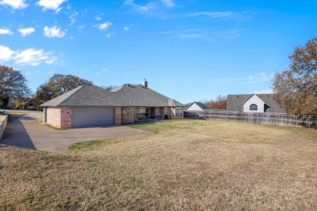 exterior space with a garage and a lawn