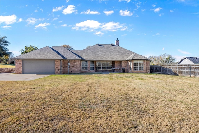 ranch-style home featuring a garage and a front lawn