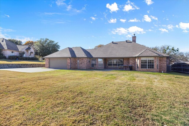 ranch-style house with a garage and a front yard