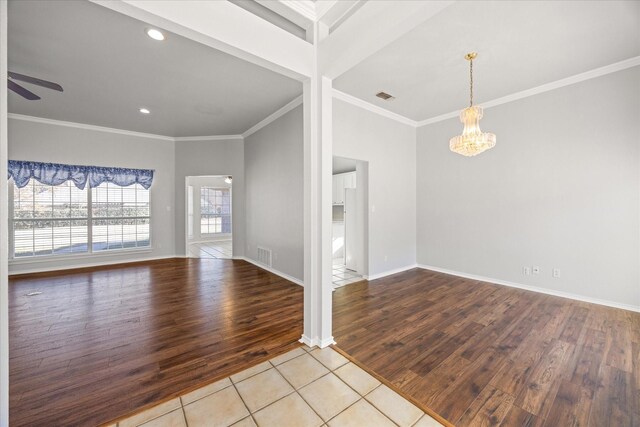 interior space featuring ornamental molding, ceiling fan with notable chandelier, and light hardwood / wood-style flooring