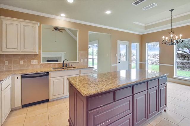 kitchen featuring decorative backsplash, stainless steel dishwasher, ceiling fan with notable chandelier, sink, and light tile patterned floors