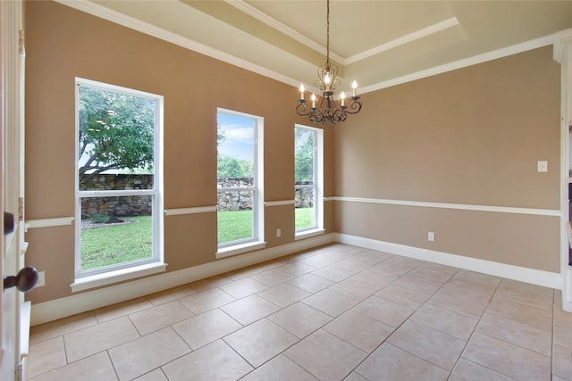 empty room featuring a tray ceiling, light tile patterned floors, ornamental molding, and an inviting chandelier