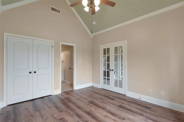 unfurnished bedroom with hardwood / wood-style floors, high vaulted ceiling, french doors, ceiling fan, and ornamental molding