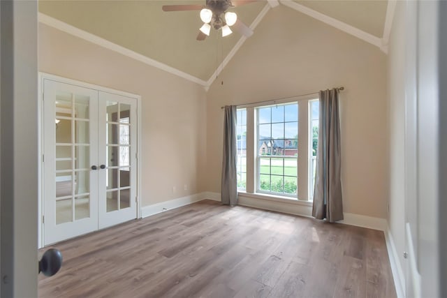 empty room with ceiling fan, french doors, high vaulted ceiling, light hardwood / wood-style floors, and ornamental molding