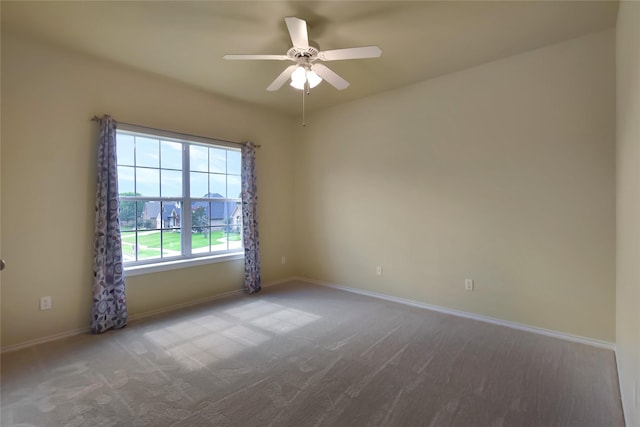 spare room featuring ceiling fan and carpet