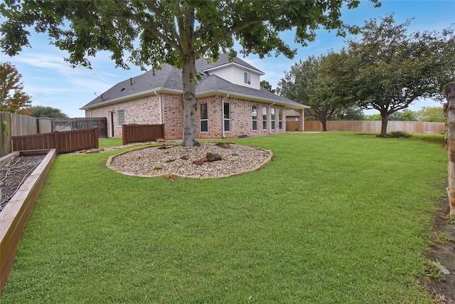 rear view of house with a yard