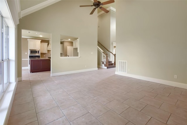 unfurnished living room featuring high vaulted ceiling, ceiling fan, and light tile patterned flooring