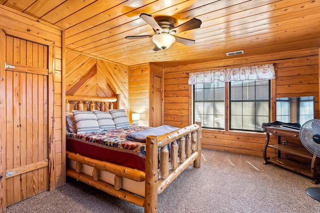 bedroom with carpet flooring, wood walls, ceiling fan, and wooden ceiling