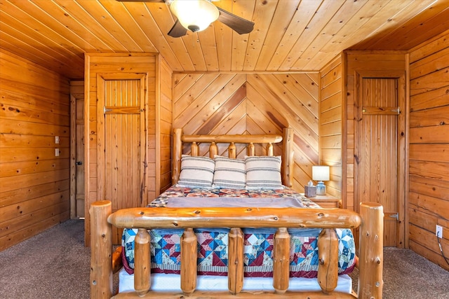 unfurnished bedroom with carpet floors, wood walls, ceiling fan, and wooden ceiling