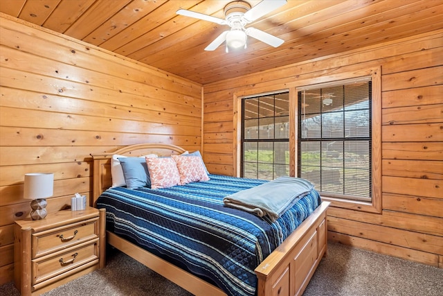 carpeted bedroom featuring ceiling fan, wood walls, and wood ceiling