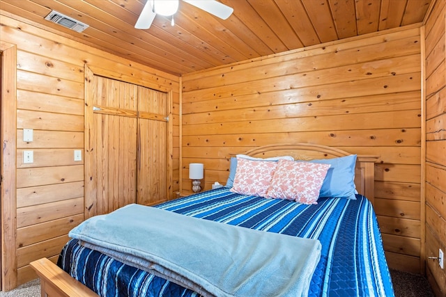 bedroom with carpet flooring, wooden walls, ceiling fan, and wooden ceiling