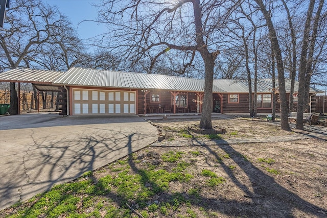 ranch-style home featuring a garage and a carport