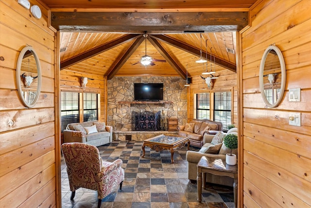 living room with wood ceiling, a stone fireplace, wooden walls, and a healthy amount of sunlight