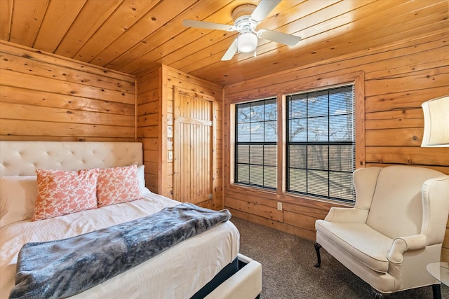 bedroom featuring carpet floors, wood ceiling, ceiling fan, and wood walls