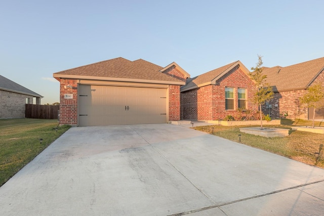 ranch-style home with a garage and a front yard