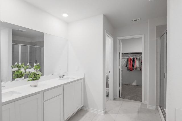 bathroom featuring tile patterned floors, vanity, and an enclosed shower