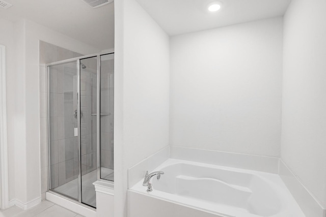 bathroom featuring tile patterned flooring and plus walk in shower