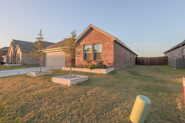 view of front of home with cooling unit, a front yard, and a garage