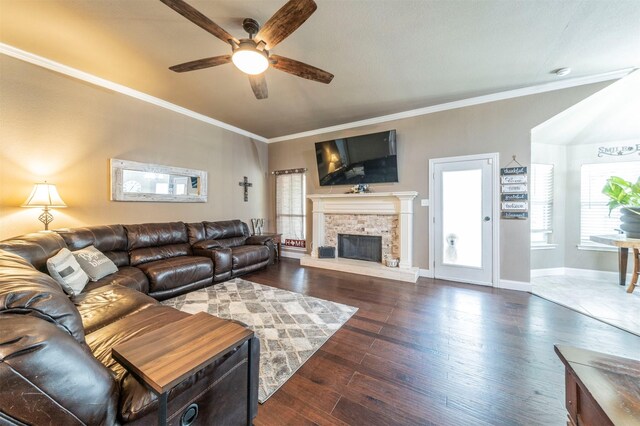 living room with a fireplace, dark hardwood / wood-style flooring, ceiling fan, and crown molding