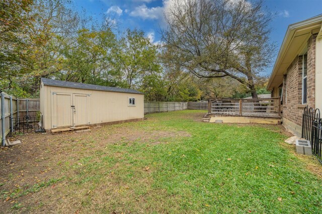 view of yard featuring a shed and a wooden deck